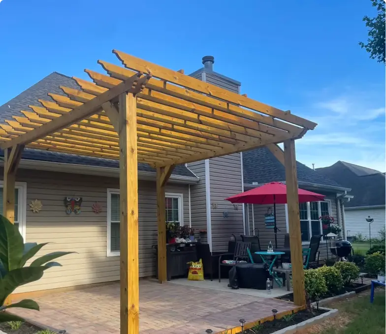 New wood pergola over a paver patio